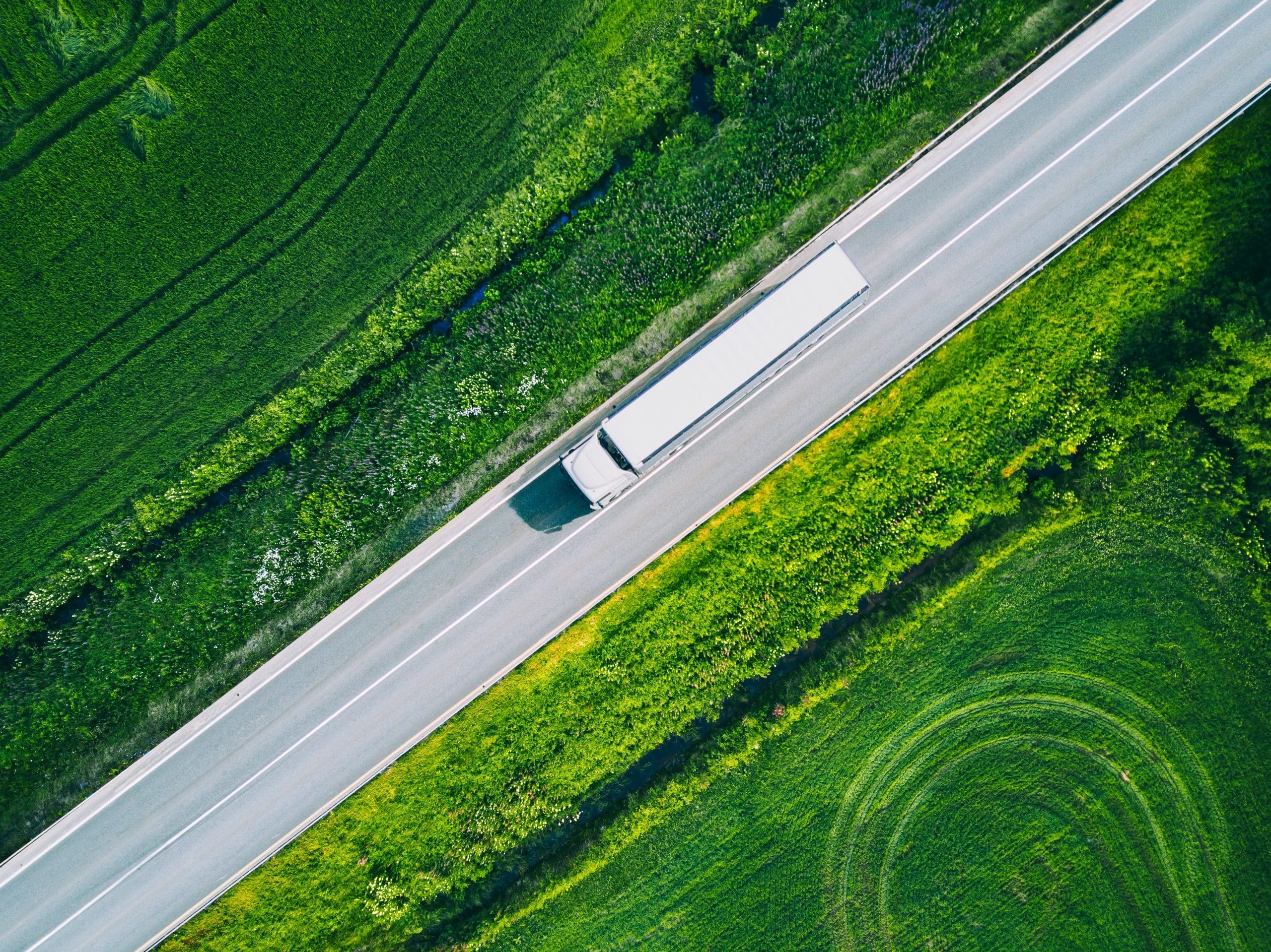 Aerial View Of A Road With A Logistics Truck Driving On It In Gr