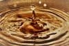 Close Up Of Golden Water Droplets Splashing