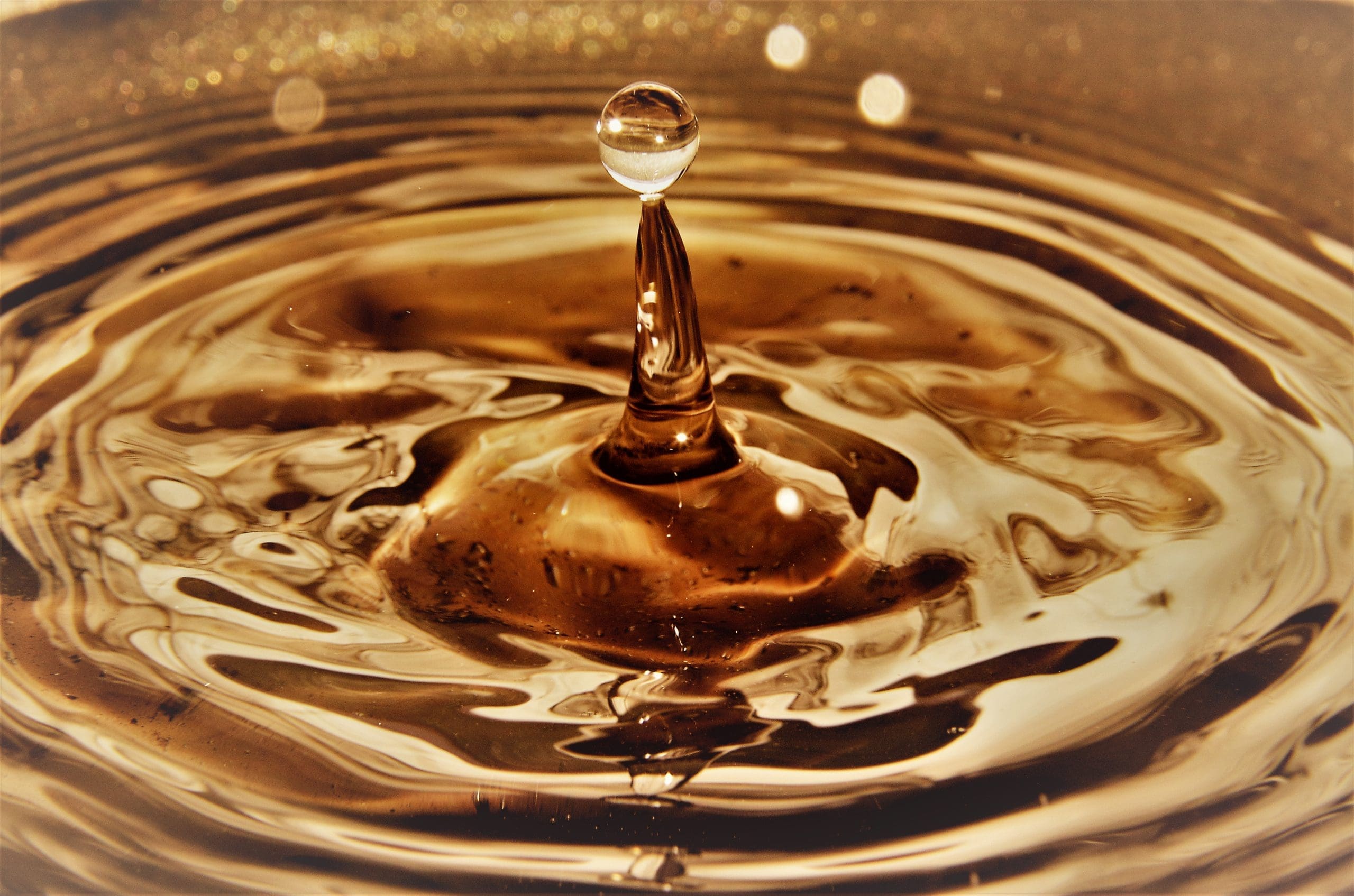 Close Up Of Golden Water Droplets Splashing