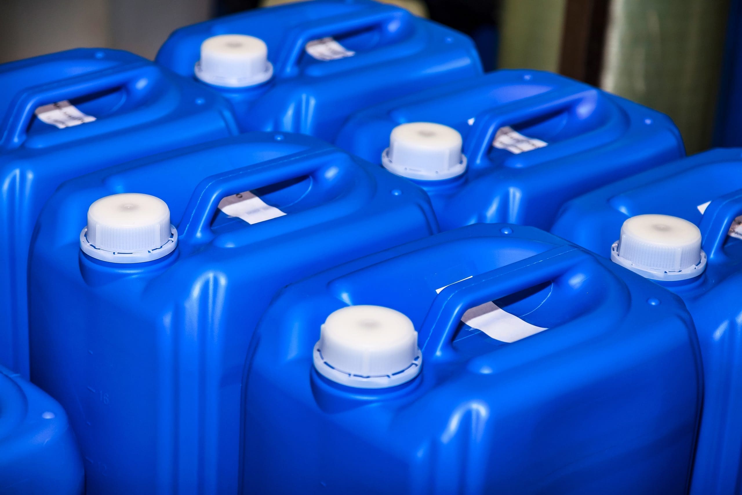 Close Up Of Some Liquid Cans Stands On Warehouse Storage Of Chemical Liquids