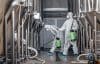 Craft Brewery, Eco Product And Disinfection. Workers In Hazmat Suits Clean Plant