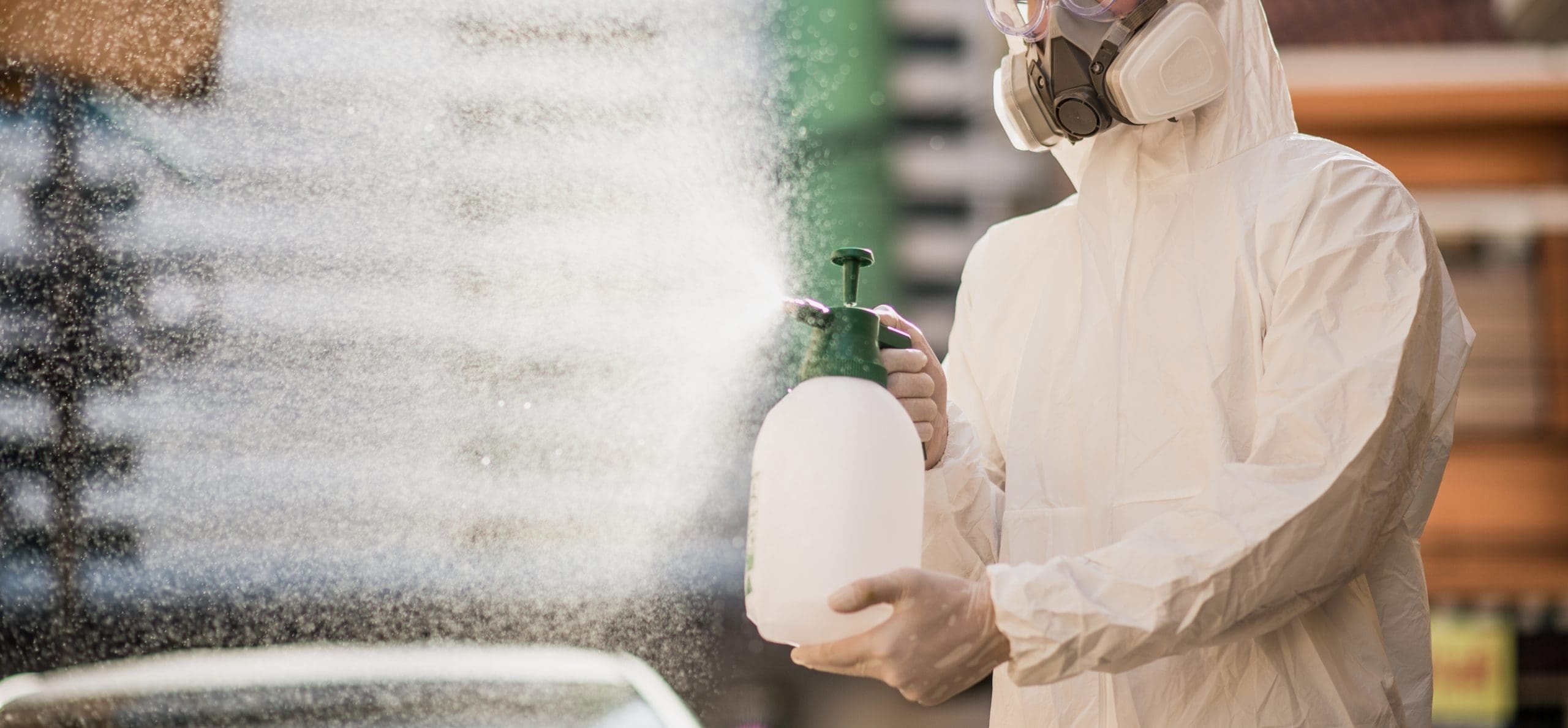 Disinfection Specialist In Ppe Suit Performing Spray Public Deco