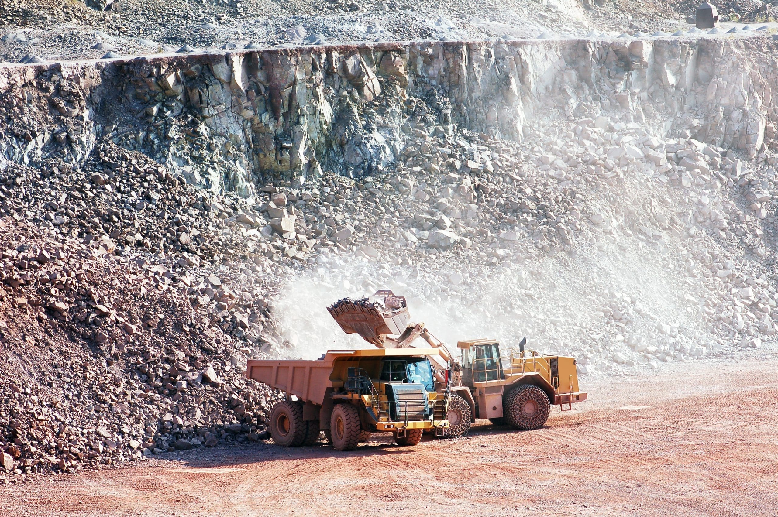 Eath Mover Loading Stones On A Dumper Truck