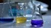 Flasks With Yellow And Blue Liquid In Chemistry Lab.