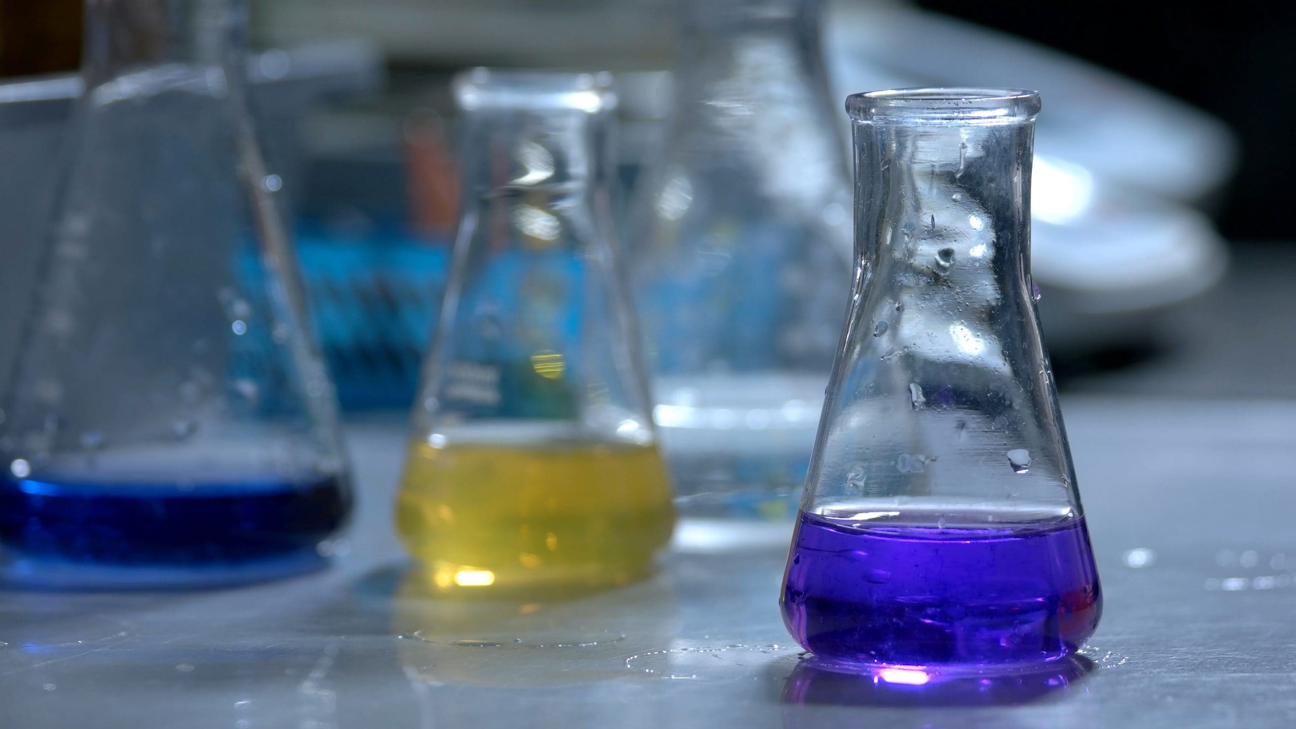 Flasks With Yellow And Blue Liquid In Chemistry Lab.