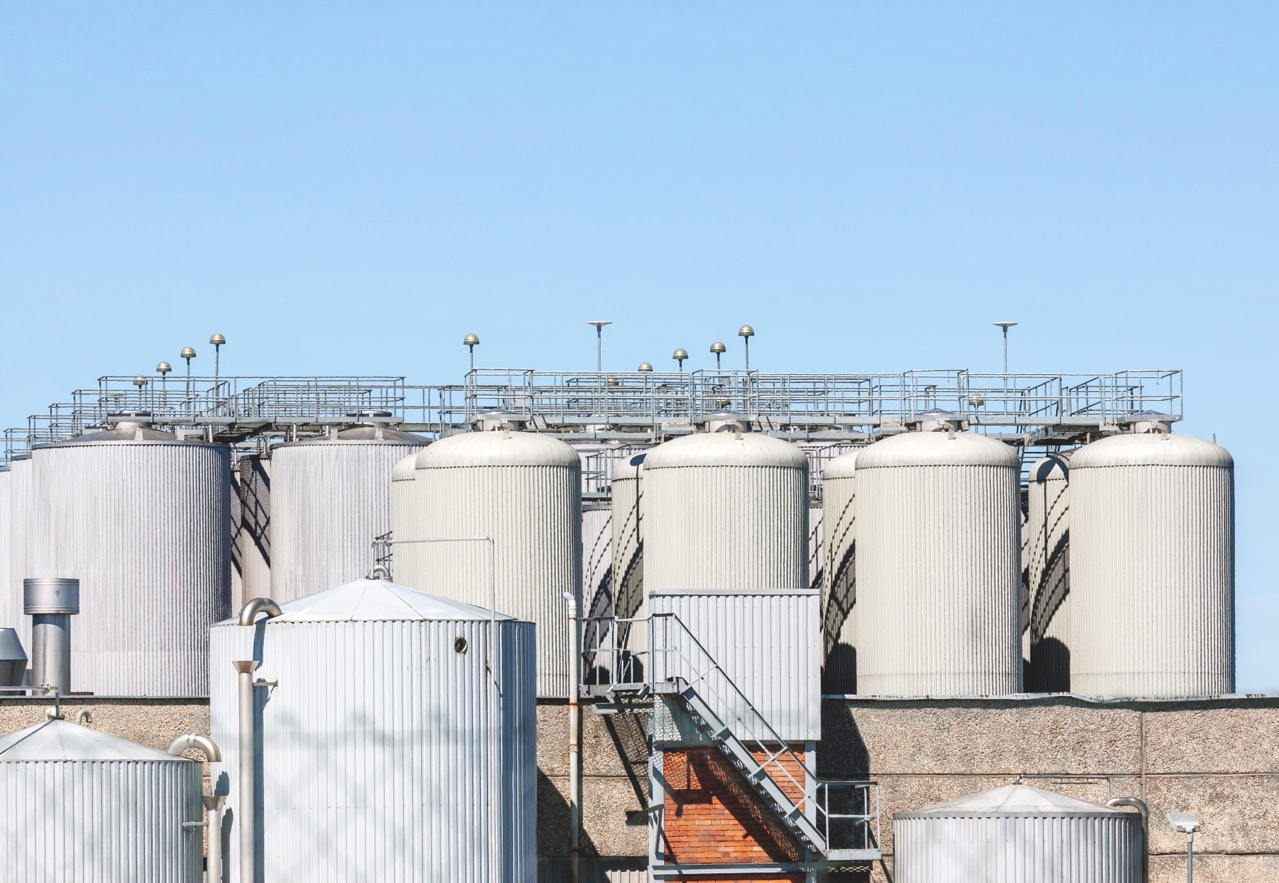 Industrial Building With Goup Of Metal Storage Tanks