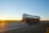 Petrol Cargo Truck Driving On Highway Hauling Oil Products. Delivery Transportation And Logistics Concept