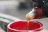 Pouring Liquid Into Red Funnel For Engine Maintenance