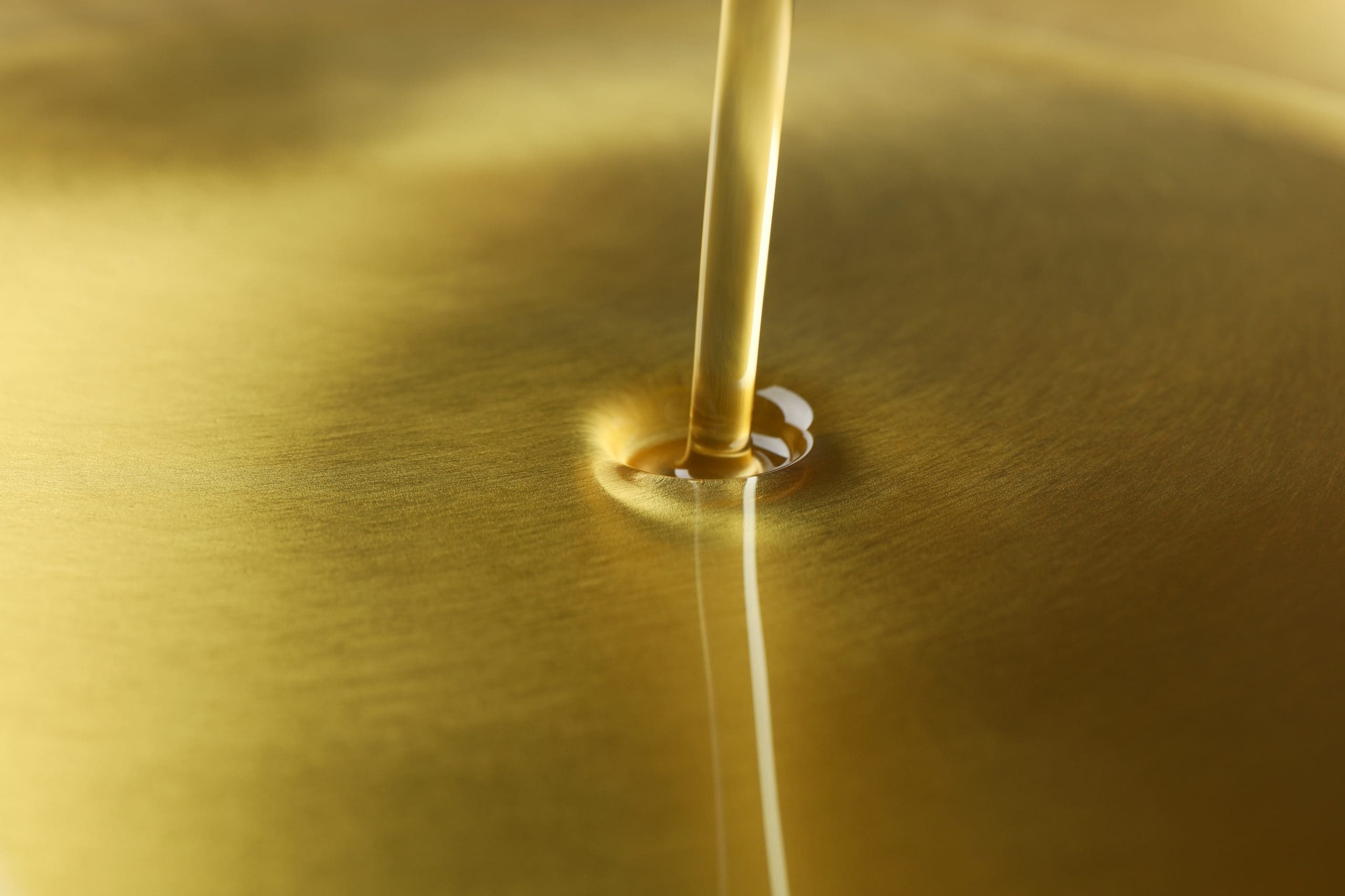 Pouring Olive Oil Texture Background, Close Up And Space For Tex